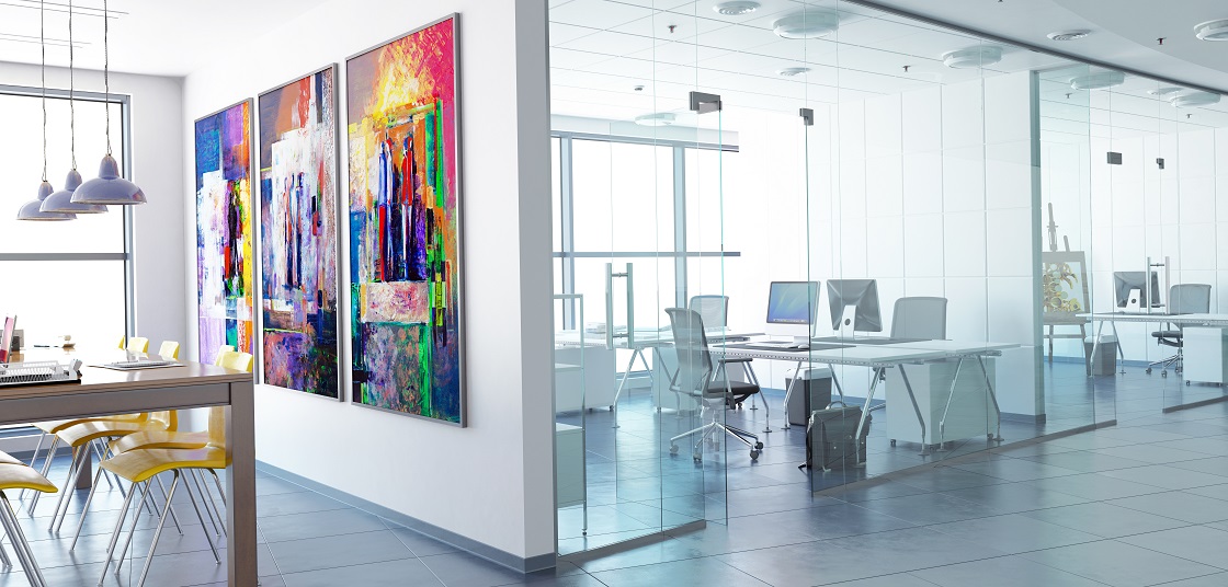 Offices with glass partition, desks, chairs, colourful artwork, tables and chairs